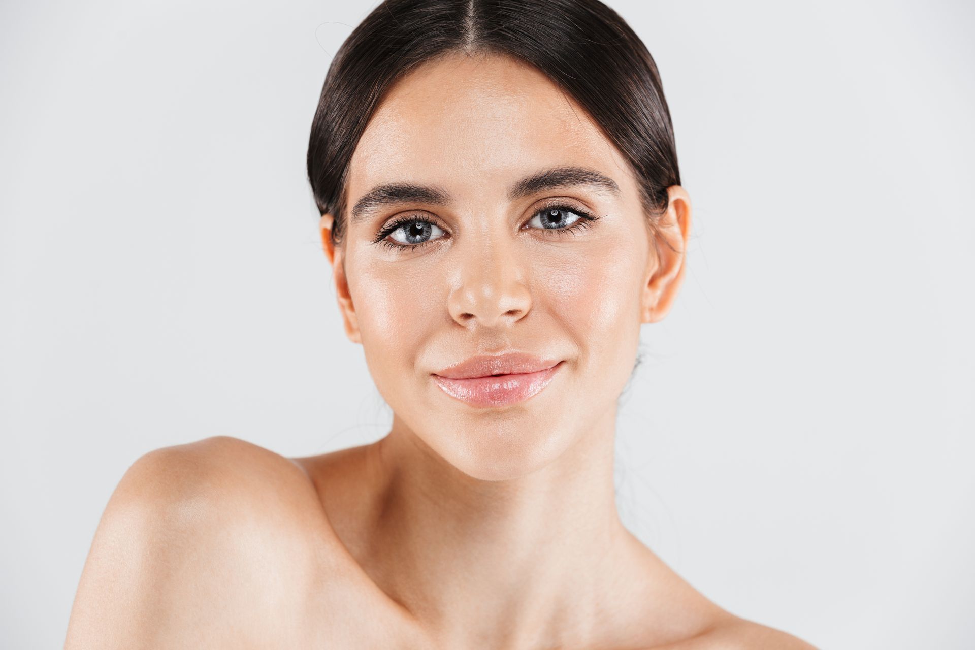 A close up of a woman 's face with a smile on her face.