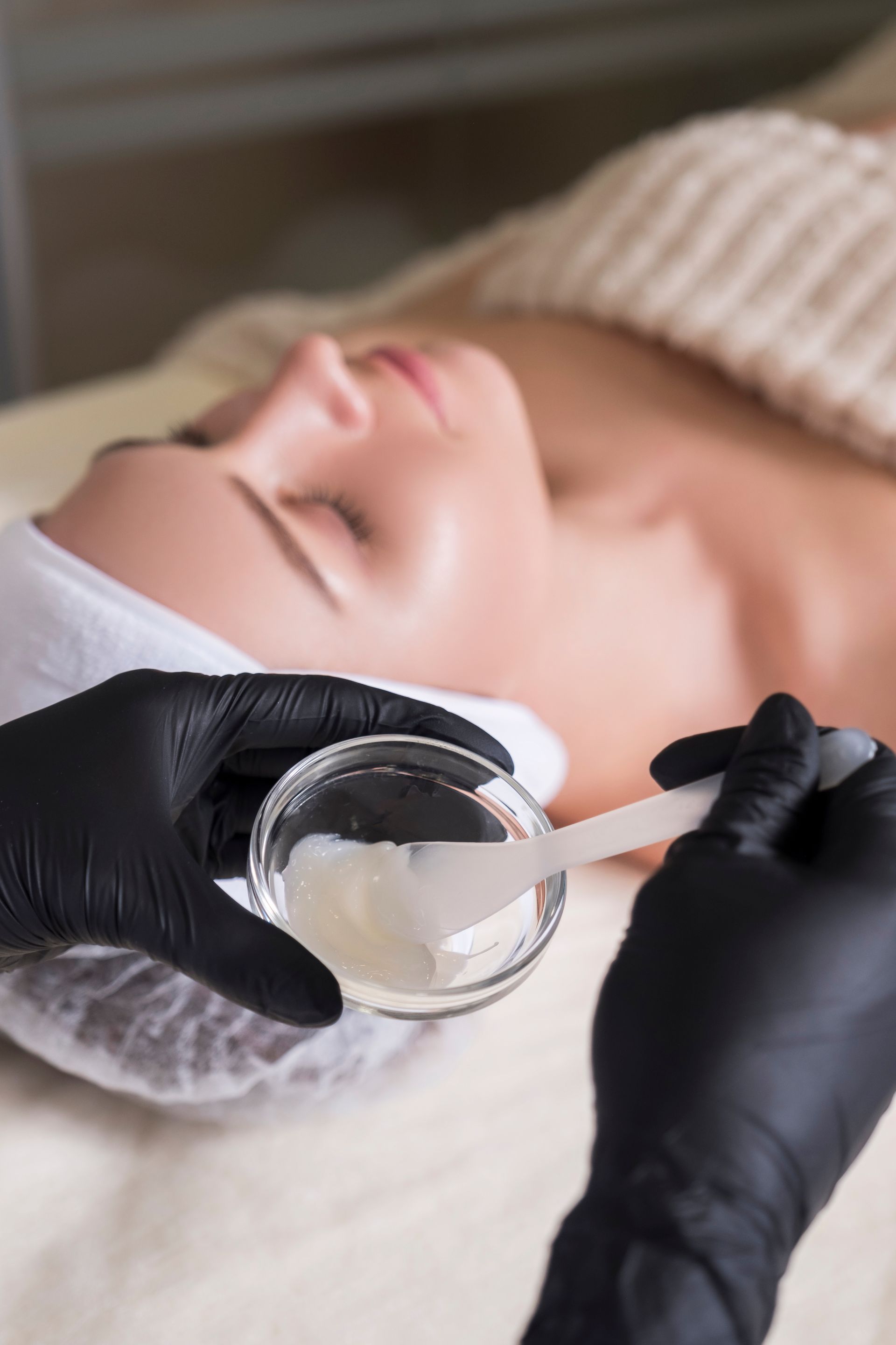 A woman is getting a facial treatment at a spa.