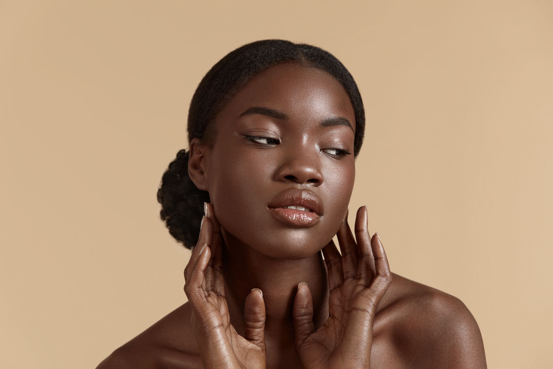 A close up of a woman 's face with her hands on it.