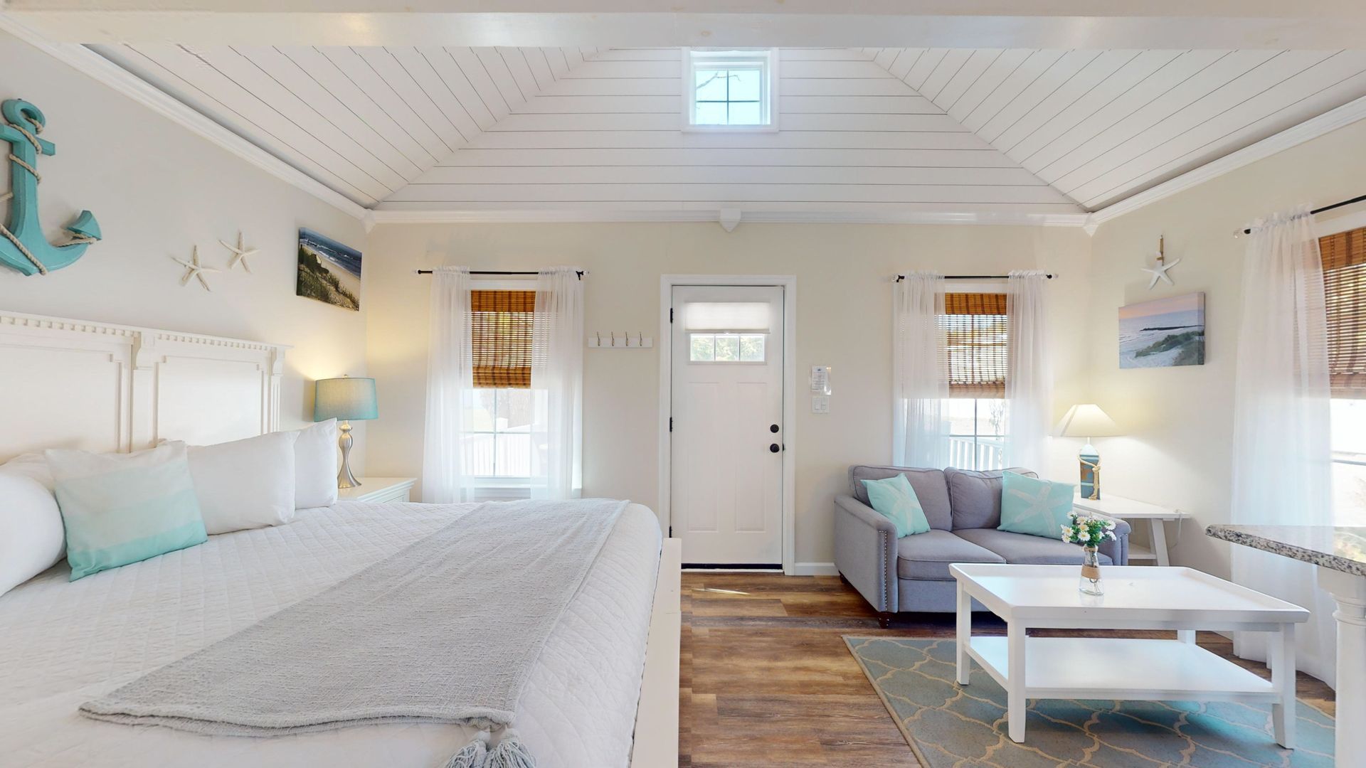 A bedroom with a bed , couch , and coffee table.