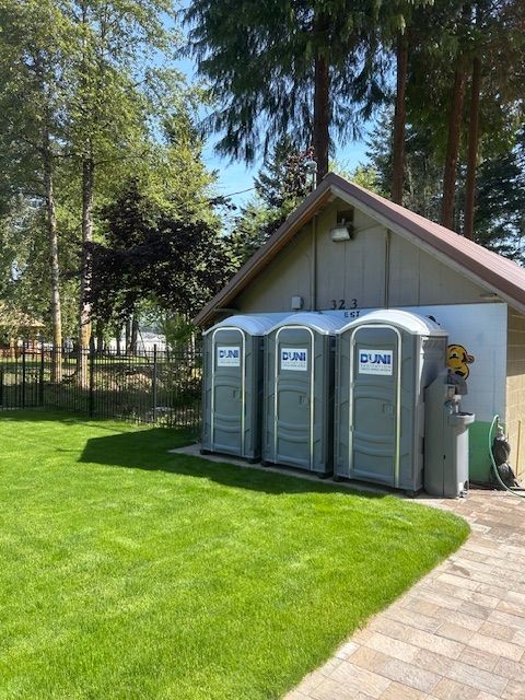 A row of portable toilets in front of a building