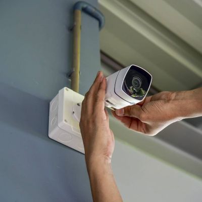 person installing security camera