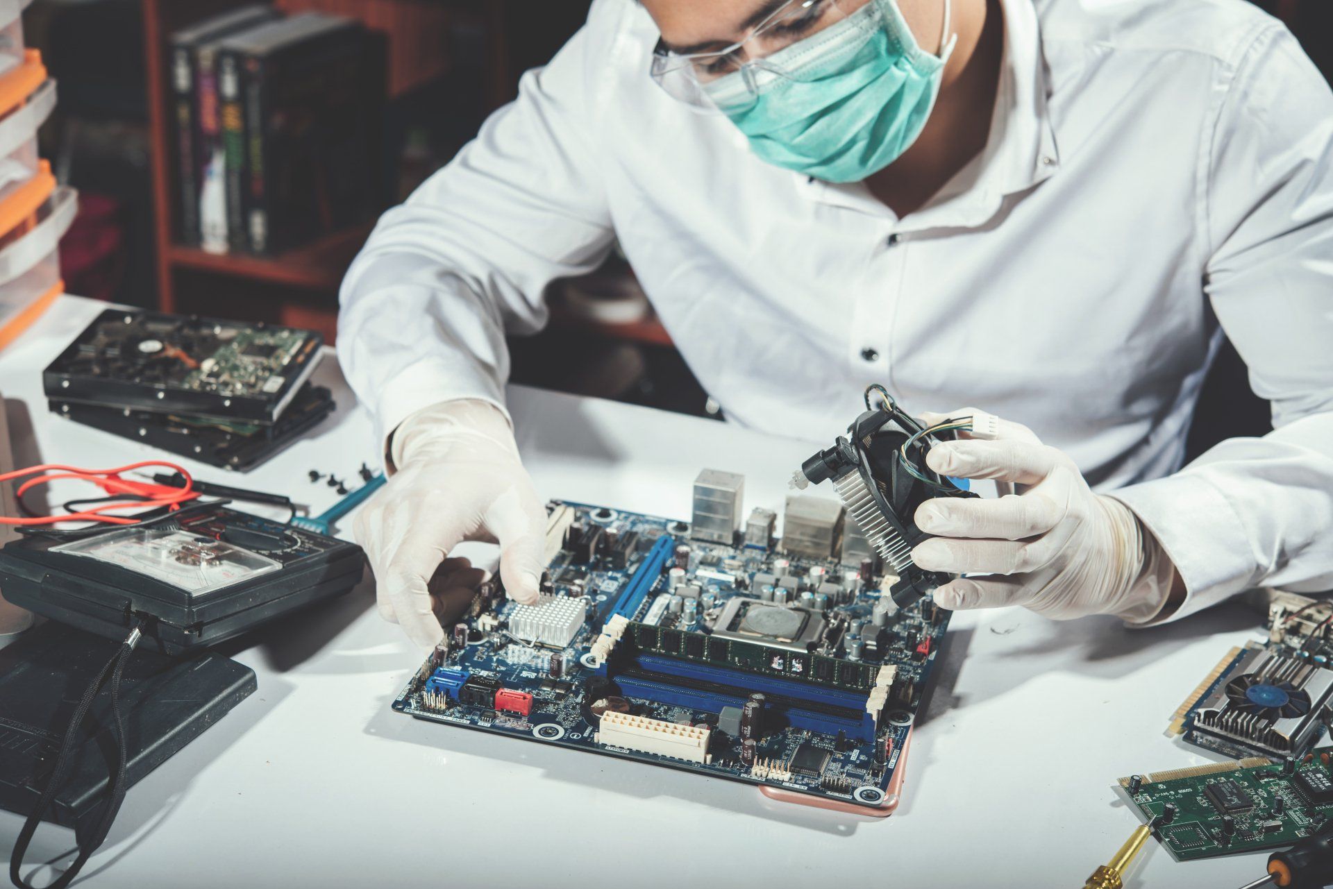 man repairing computer and motherboard