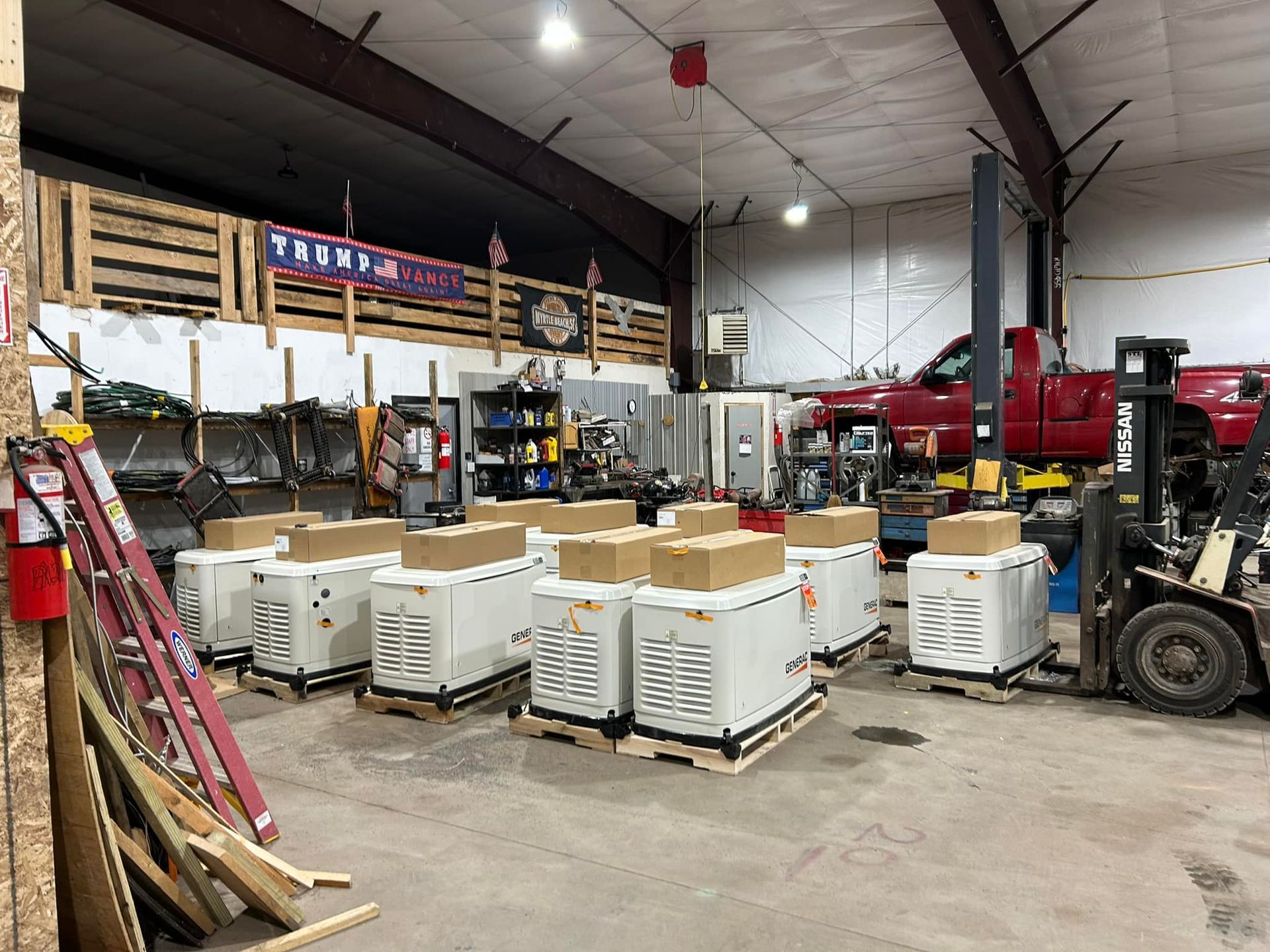 American Electric LLC | A forklift is moving a bunch of generators in a garage.