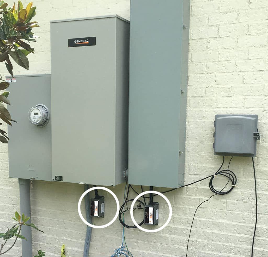 American Electric LLC | A brick wall with electrical boxes and wires attached to it