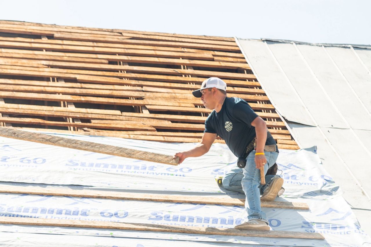 Man Holding Wood — Greenwood, SC — Roofing Unlimited & More