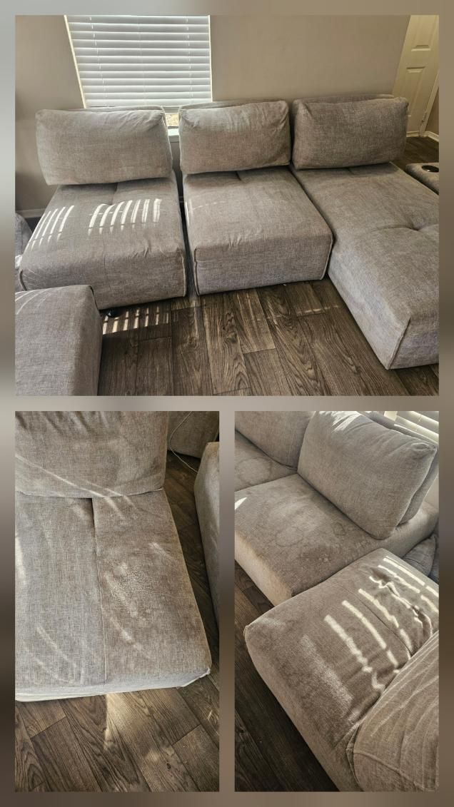 A light gray sectional sofa with matching ottoman in a room with wooden floors and blinds.