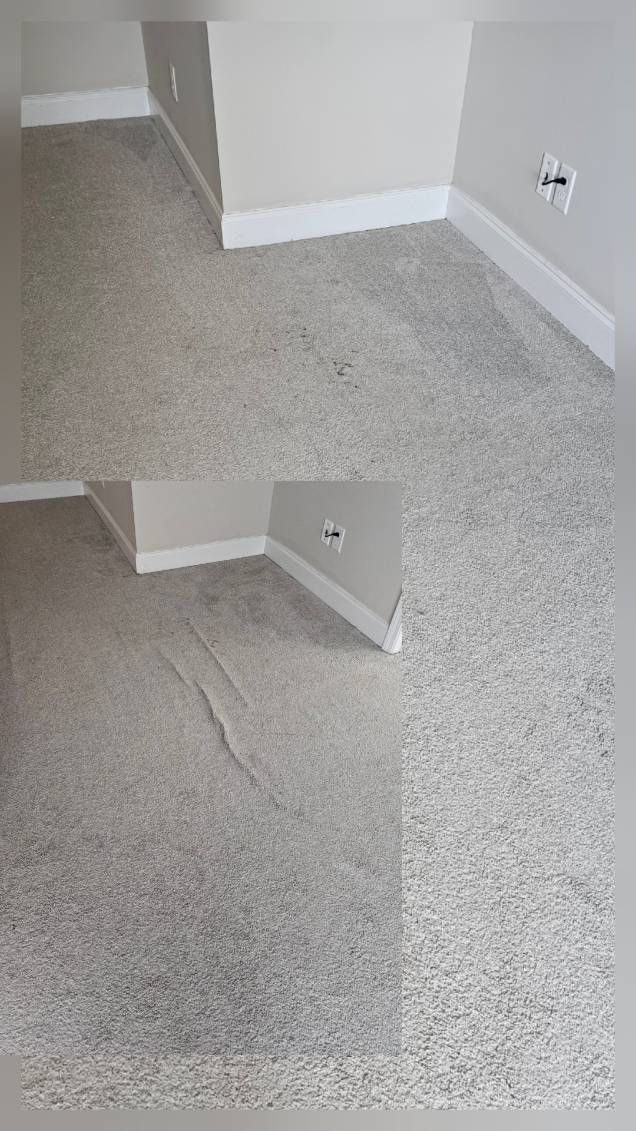 Beige carpeted room with white baseboards and wall corners. Visible wrinkles in carpet.