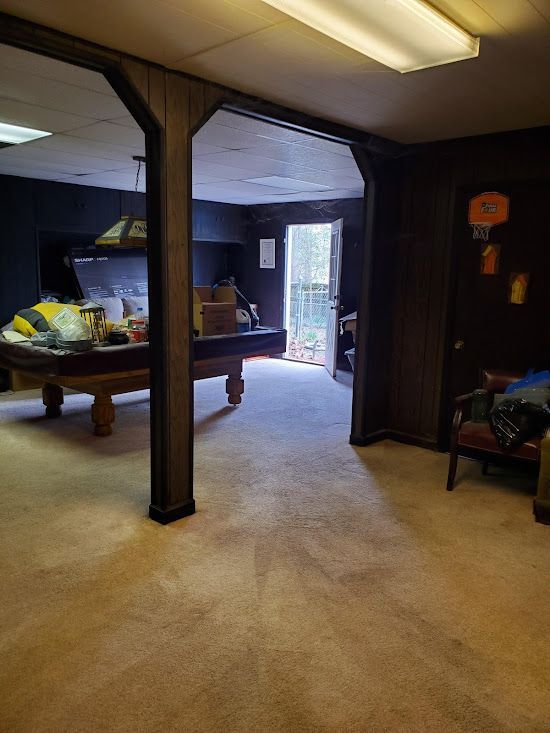 There is a pool table in the middle of the room.