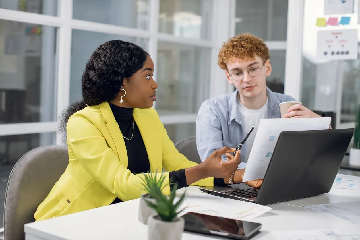 A woman is holding an open sign in front of a blue door