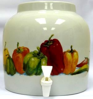 Ceramic beverage dispenser decorated with colorful bell peppers; features a white spigot.