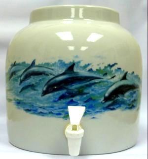 Ceramic water dispenser with dolphins painted on it. Features a white spout.