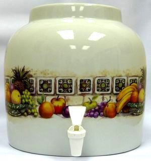 Ceramic beverage dispenser with fruit pattern and spigot.