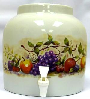 White ceramic water dispenser with fruit decals, spigot.