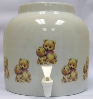 Ceramic beverage dispenser with fruit pattern and spigot.