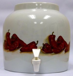 White ceramic beverage dispenser with red chili pepper design and spigot.