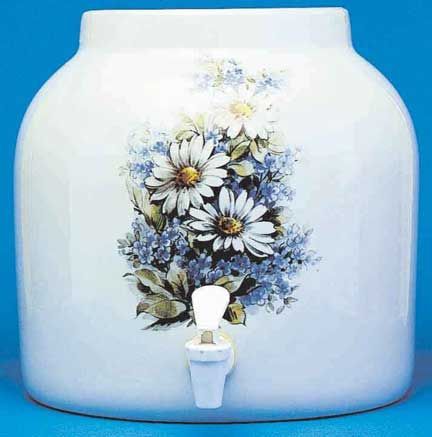 White ceramic water dispenser with daisy and blue floral design, spigot at base.