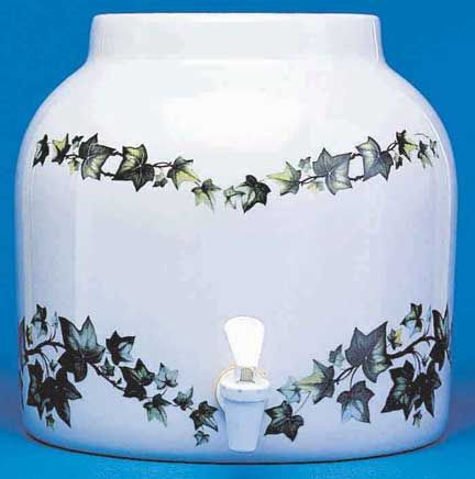 White ceramic water dispenser with ivy design and a spigot.
