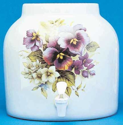 White ceramic water dispenser with floral design and spigot.