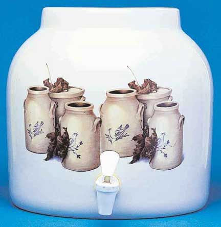 White ceramic beverage dispenser with a spigot, decorated with jar motifs and leafy vines.