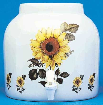 White ceramic water dispenser with sunflower design and a spigot.