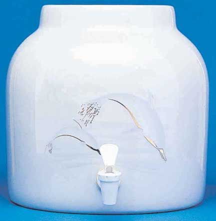 White ceramic water dispenser with a dolphin design, spigot, on a blue backdrop.