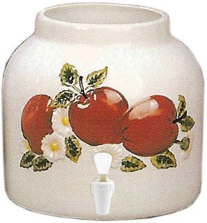 White ceramic beverage dispenser with red apple and floral design.
