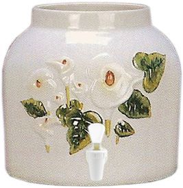 Ceramic water cooler with white flowers and green leaves. White spigot at the bottom.