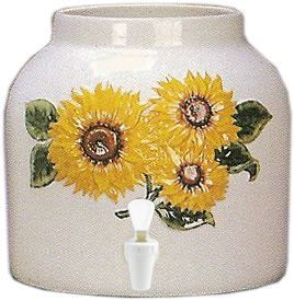White ceramic water dispenser with sunflower design and a white spigot.