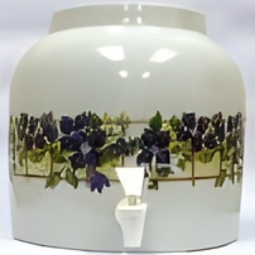 White ceramic water dispenser with purple grapes and green leaves, a white spout.
