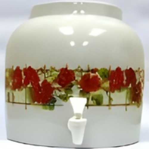 White ceramic water dispenser with red floral design and white spigot.