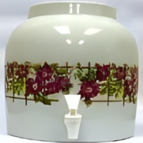 Ceramic water dispenser with Native American-style designs and spigot. Beige with brown and yellow accents.