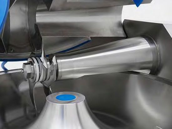 A close up of a stainless steel mixer with a blue lid.