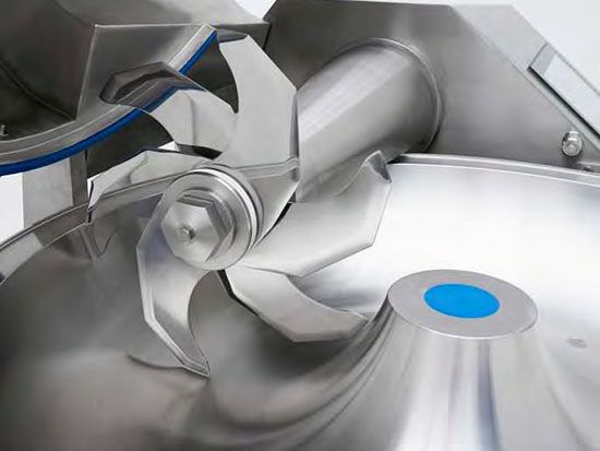 A close up of a stainless steel machine with a blue circle in the middle.