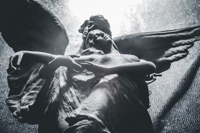 Angel statue at a gravesite symbolizing remembrance and peace.
