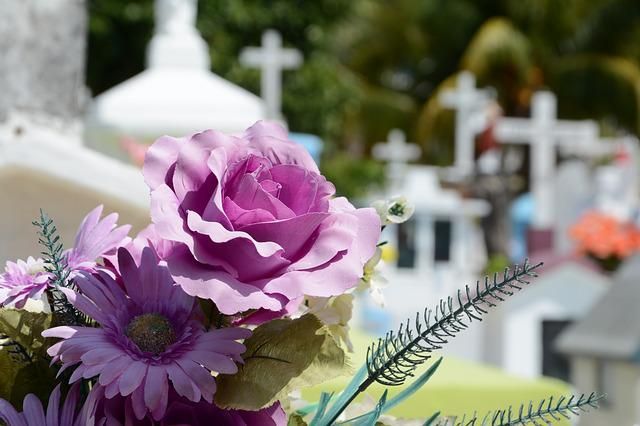 Purple and pink flowers placed at a gravesite in Los Alamitos, CA, funeral homes in Los Alamitos, CA