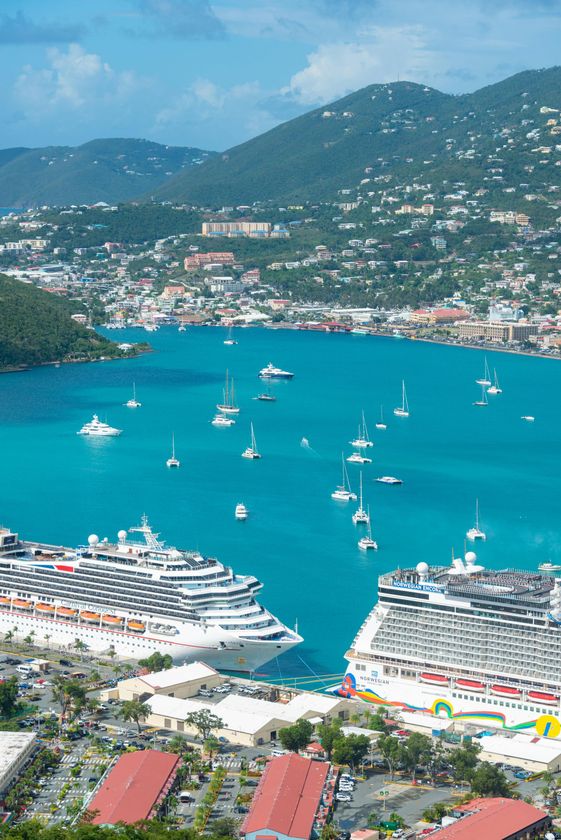 View of Charlotte Amalie harbor, St. Thomas, with cruise ships, sailboats, turquoise water, and town on a hillside.
