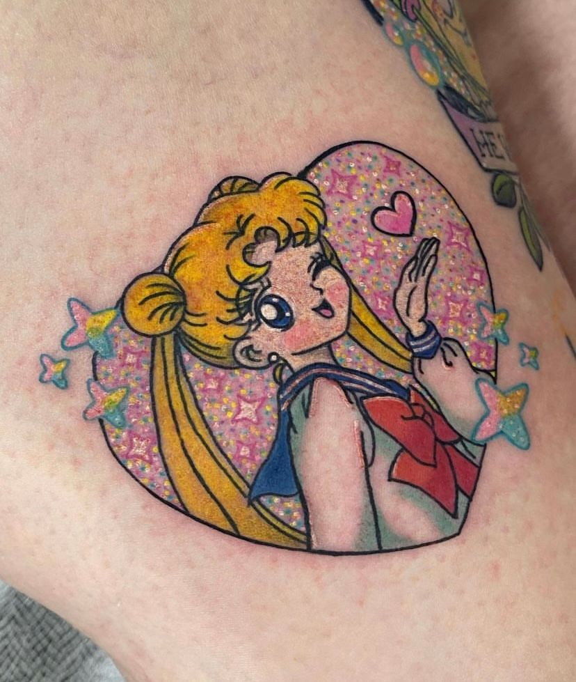 A sailor moon tattoo on a person 's leg