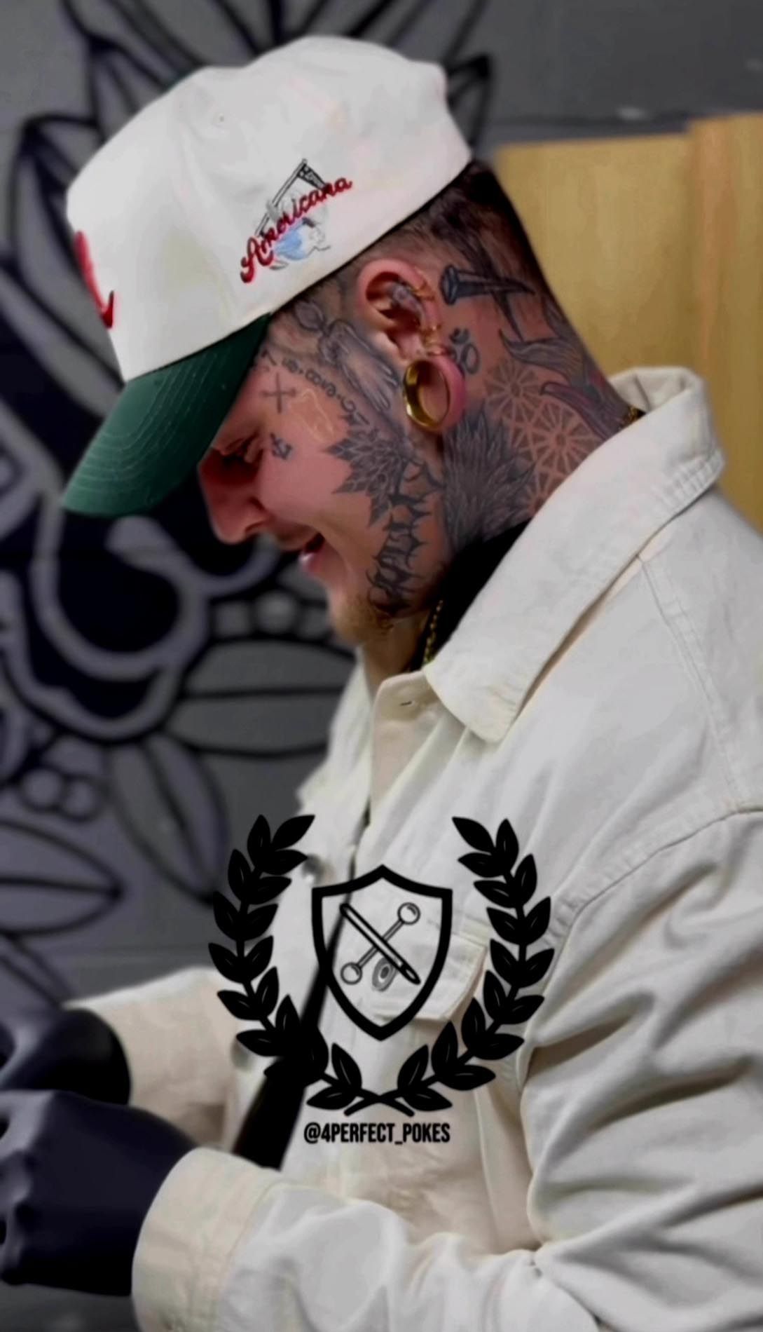 A man with a lot of tattoos on his face is wearing a hat