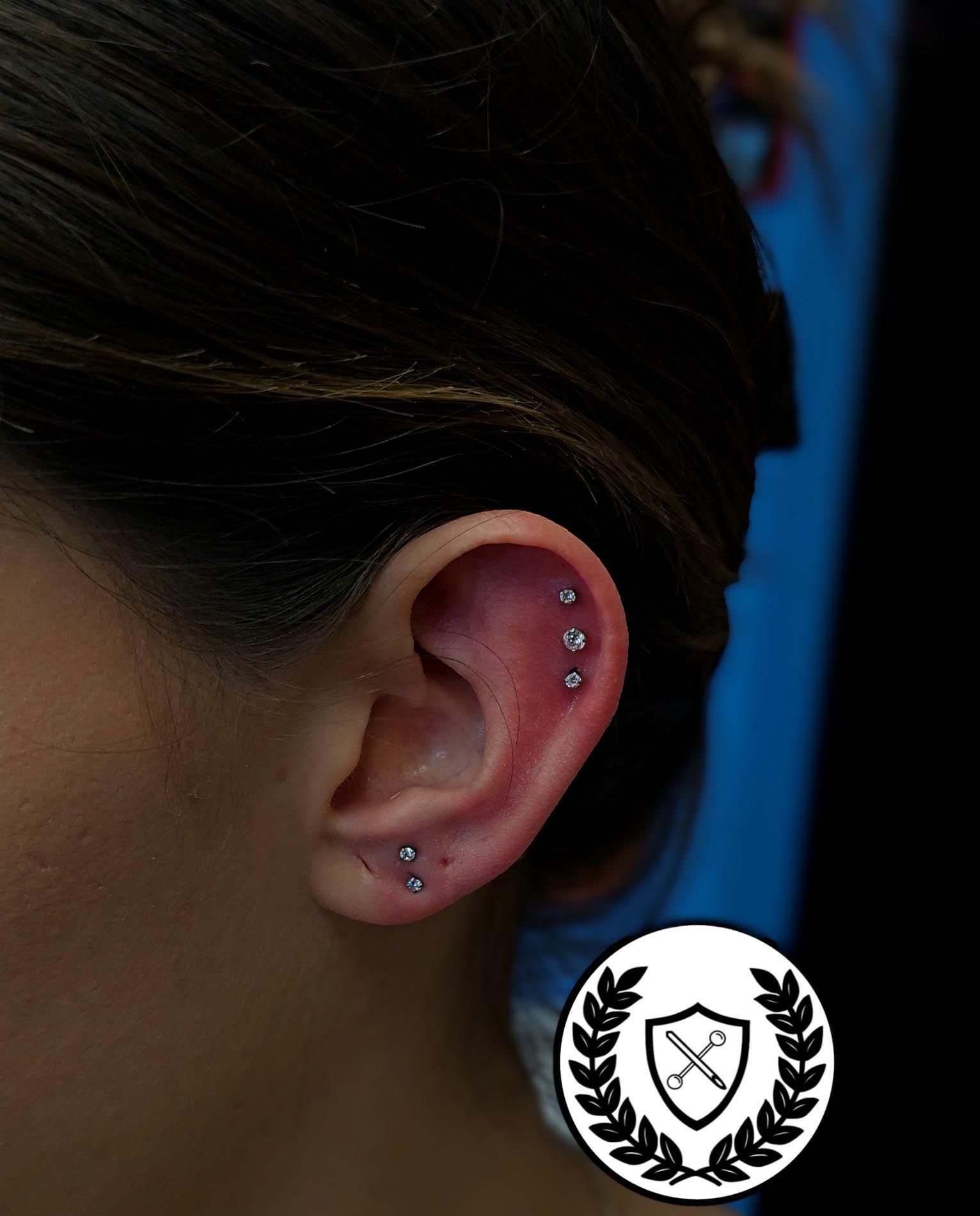 A close up of a woman 's ear with a laurel wreath on it