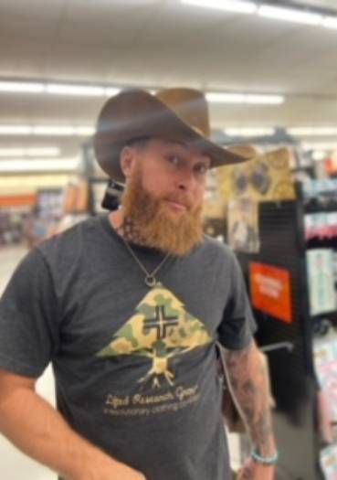 A man with a beard wearing a cowboy hat