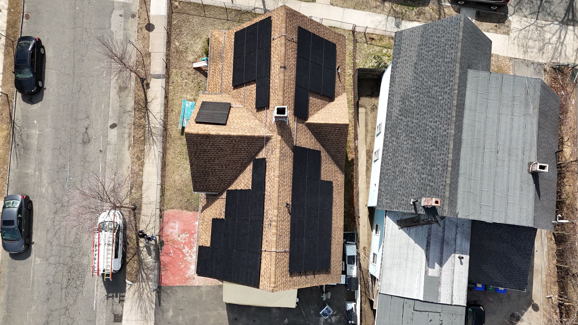 An aerial view of a house under construction in a residential area.