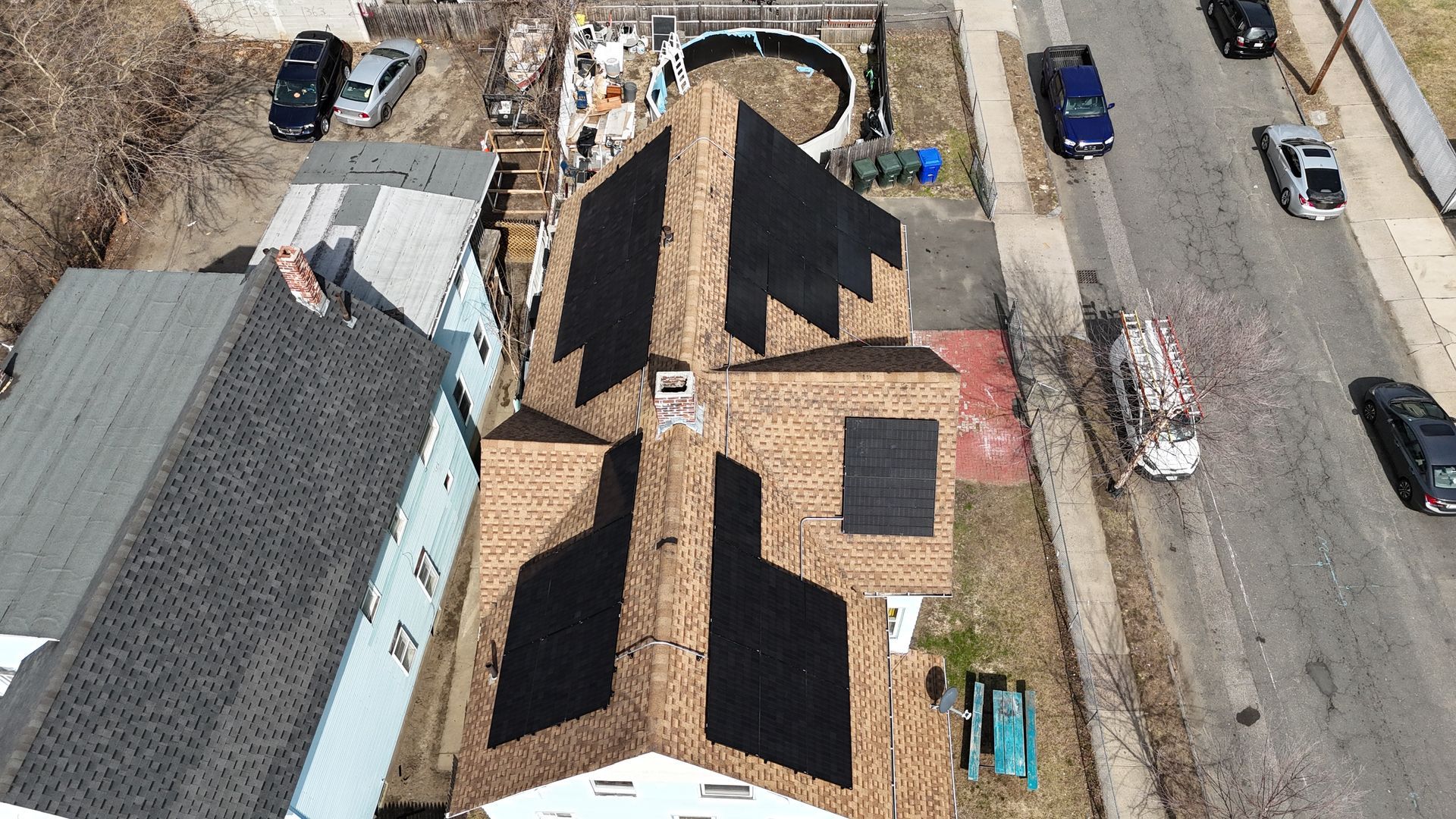 An aerial view of a house under construction with a black roof.