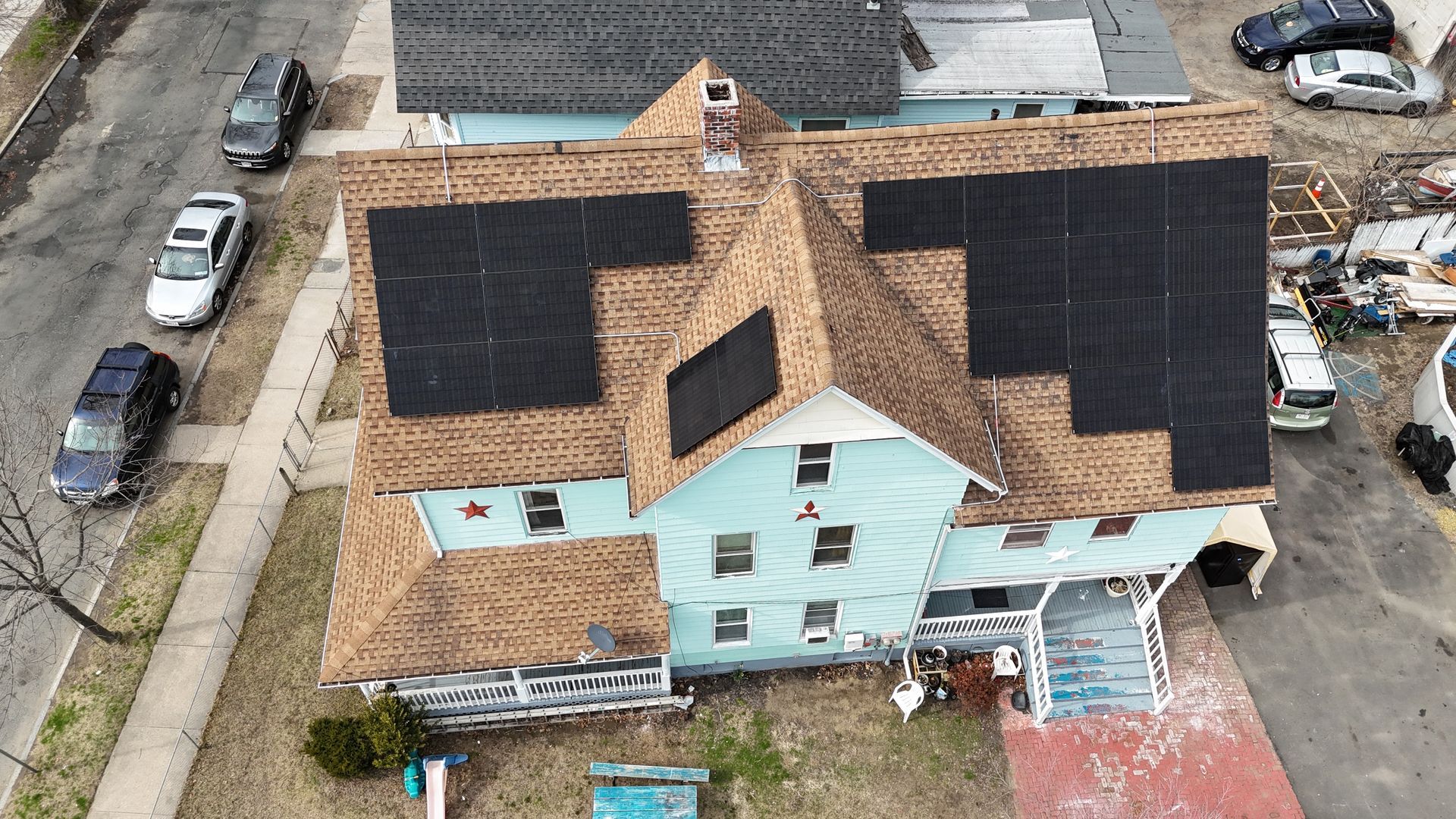 An aerial view of a house with a roof that is being repaired.