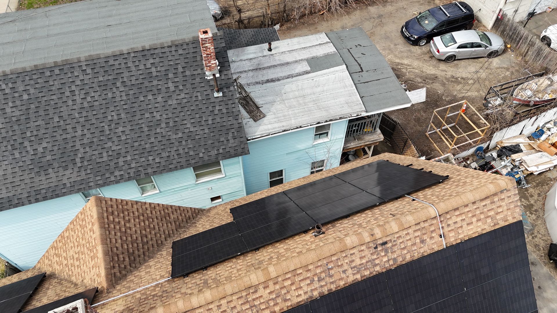 An aerial view of a house with solar panels on the roof.