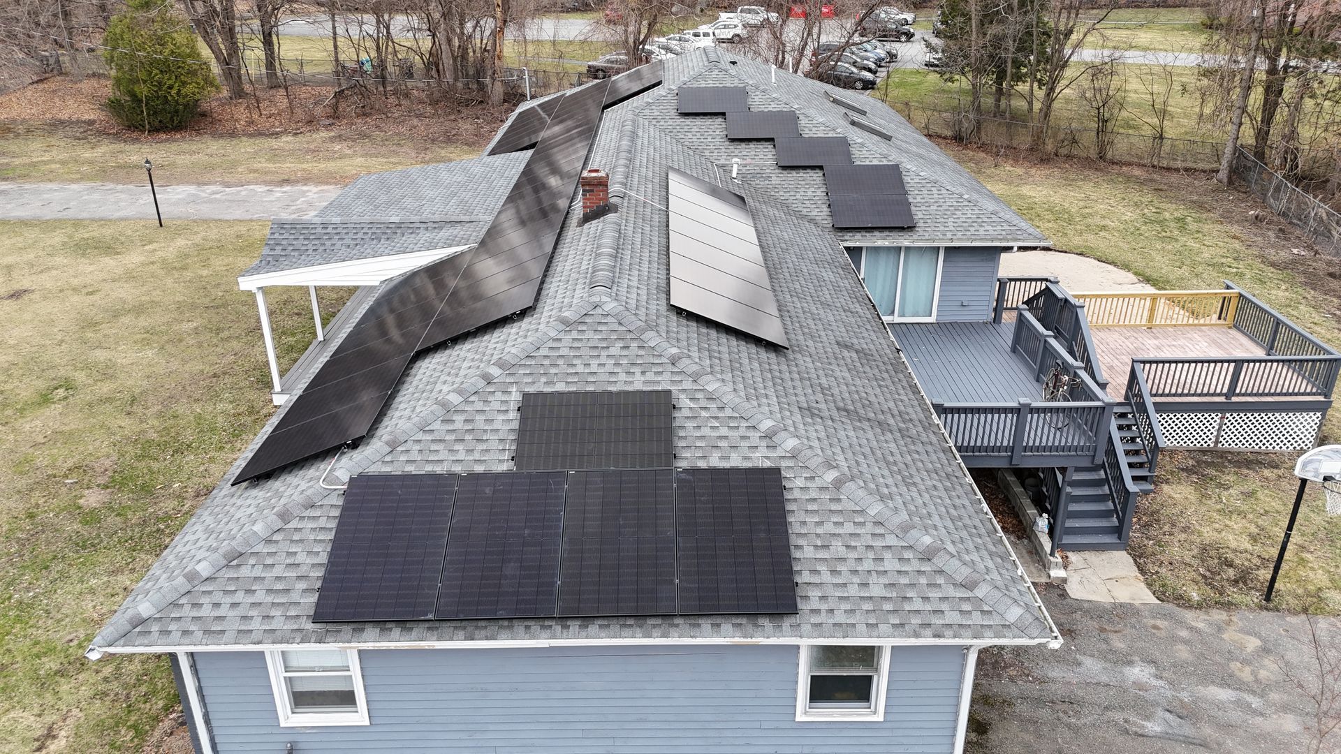 An aerial view of a house with solar panels on the roof.