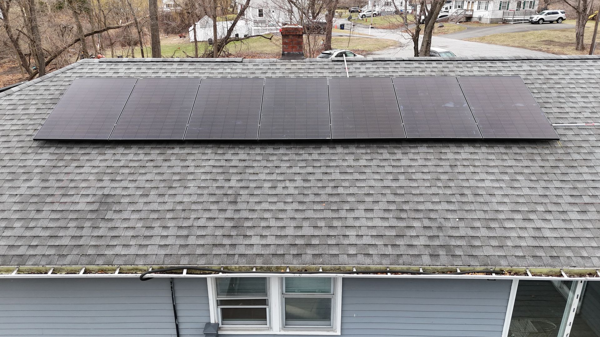 A house with a lot of solar panels on the roof.