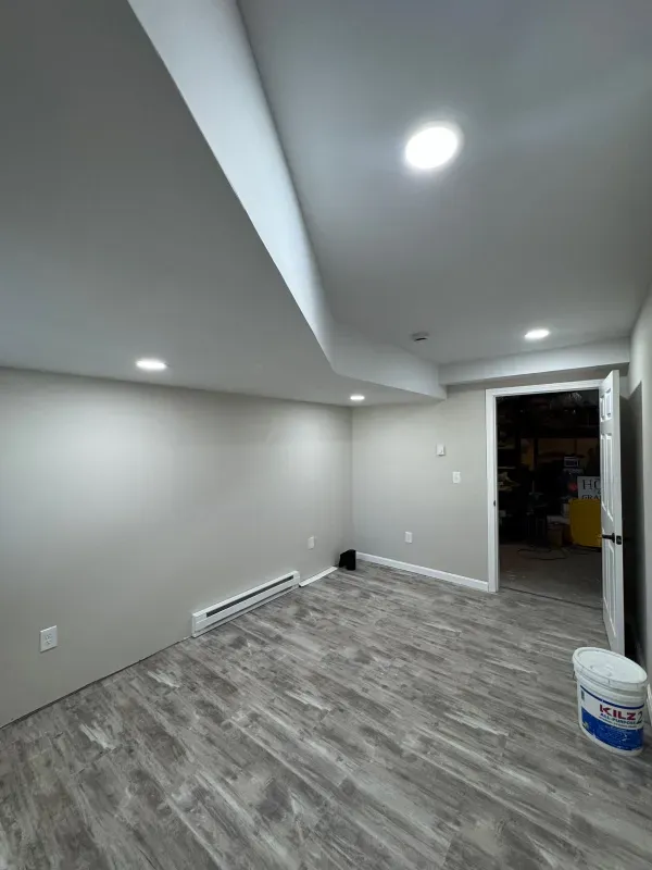 There is a bucket of paint in the middle of the room.