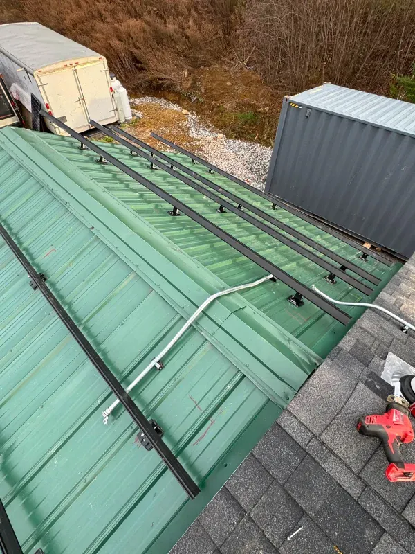 A green roof with solar panels being installed on it.