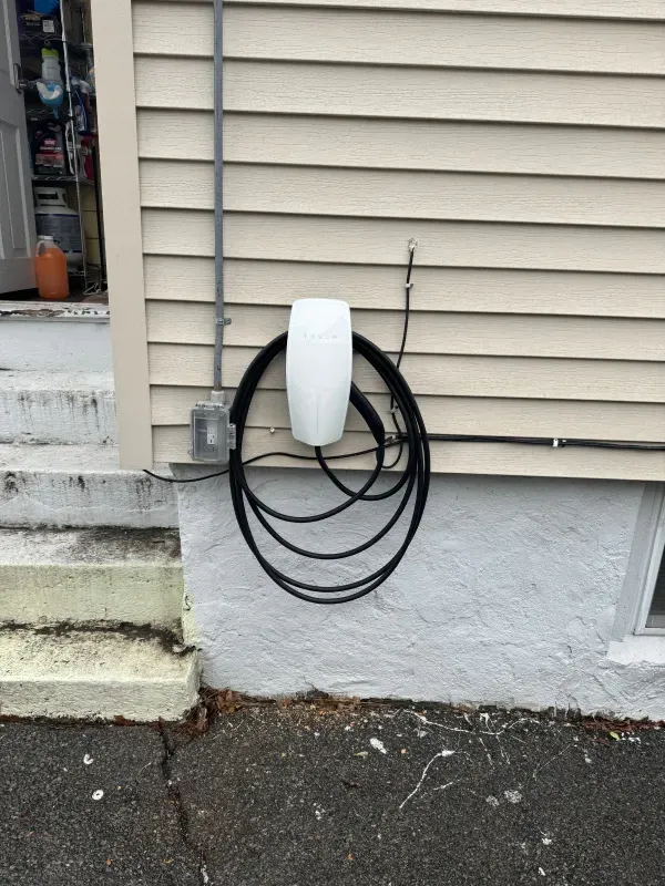 A hose is hanging on the side of a house.